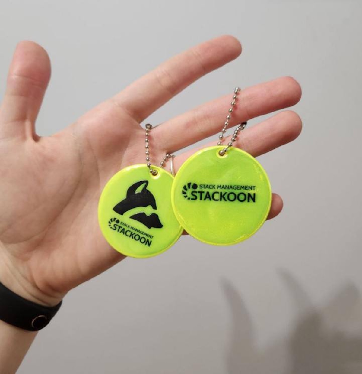 a hand holding a pair of tags
